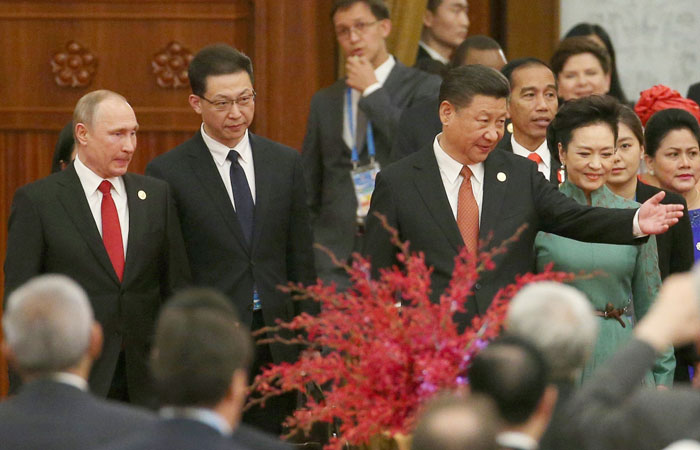 Chinese President Xi Jinping, center, beside his wife Peng Liyuan, right, gestures to Russian President Vladimir Putin, left, and other leaders as they arrive for a welcome banquet for the Belt and Road Forum at the Great Hall of the People in Beijing on Sunday. — Reuters
