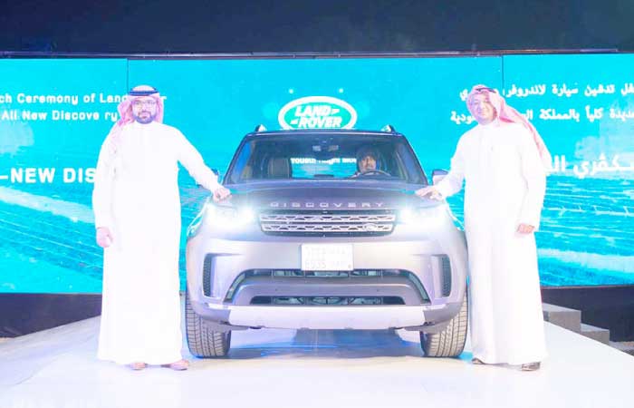 MYNM officials pose beside the new Land Rover Discovery 5 during the launch