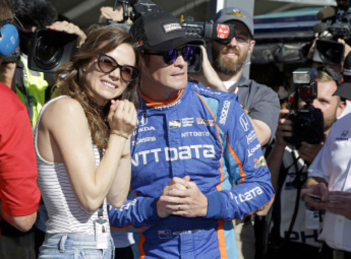 Scott Dixon, of New Zealand, watches with his wife, Emma, the final attempt to knock him off the pole during qualifications for the Indianapolis 500 IndyCar auto race at Indianapolis Motor Speedway, Sunday. — AP