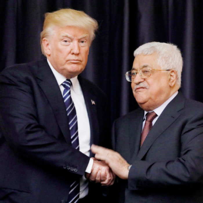 US President Donald Trump and Palestinian President Mahmoud Abbas shake hands as they conclude their meeting at the Presidential Palace in the West Bank city of Bethlehem on Tuesday. — Reuters