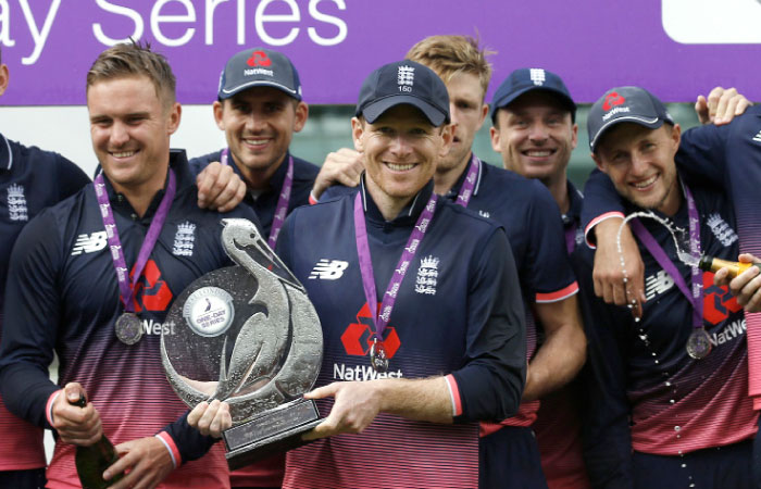 England's Eoin Morgan celebrates with the trophy after winning the three-match series against South Africa 2-1 in London on Monday. — Reuters