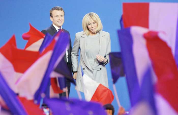 In this April 23, 2017 file photo, French centrist presidential candidate Emmanuel Macron and his wife Brigitte smile to supporters at his election day headquarters in Paris. — AP