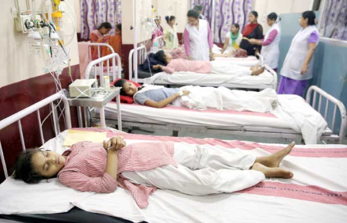Children lie on hospital beds as they receive treatment after complaining of breathlessness and eye irritation following a gas leak from a fuel tanker in New Delhi on Saturday. — Reuters