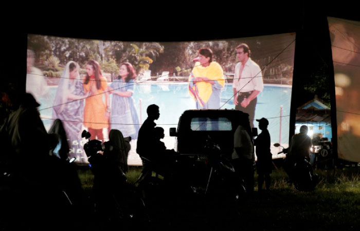 People watch a film during a wedding party in Bogor, Indonesia on Tuesday. - Reuters