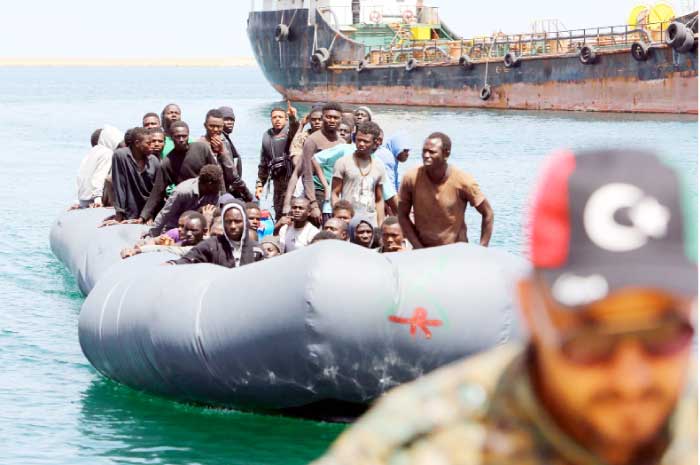 Migrants, who were rescued off the Libyan coast, arrive at the naval base in the capital Tripoli. - AFP