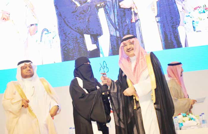 Taghraeed Al-Malki from the 14th High School in Jeddah receives her grand prize from Governor Mishal Bin Majed, Tuesday. — SG photo by Saleh Fareed