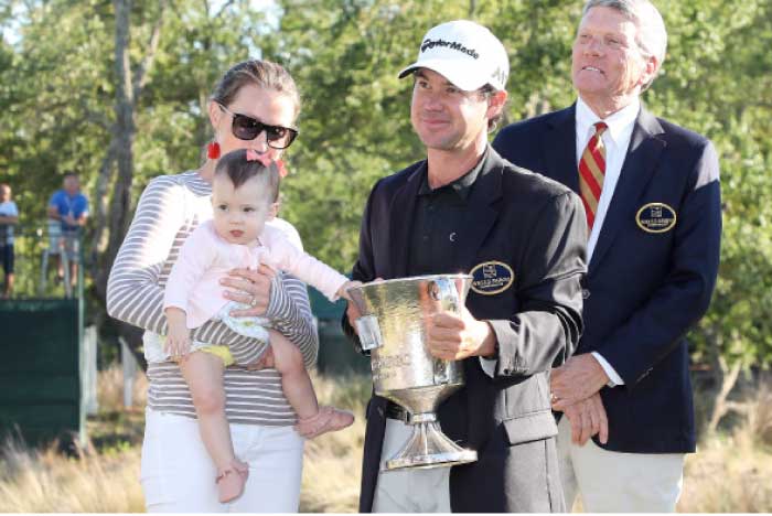 Brian Harman (C) celebrates his victory with his wife Kelly and baby during the final round of the Wells Fargo Championship golf tournament at Eagle Point Golf Club. – Reuters