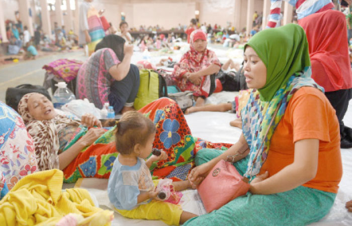 A family from Marawi rest at an evacuation center in Balo-i on the southern island of Mindanao on Monday. — AFP