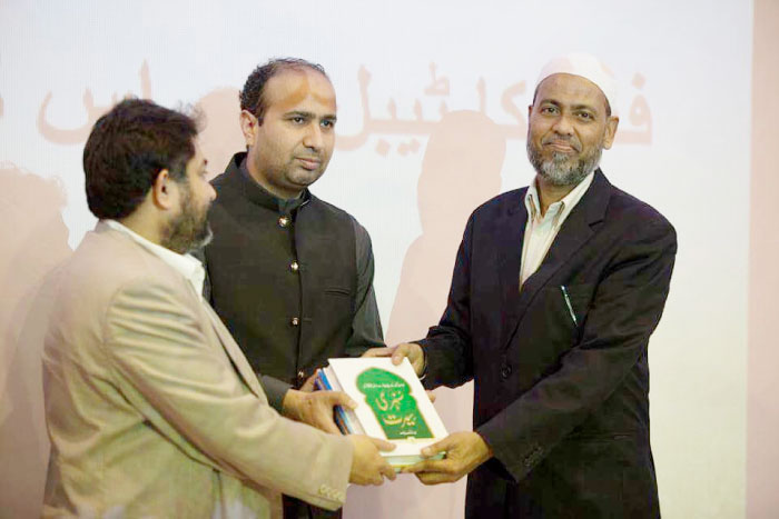 Dr. Abdulaziz Abdul Raheem, right, being awarded a memento.