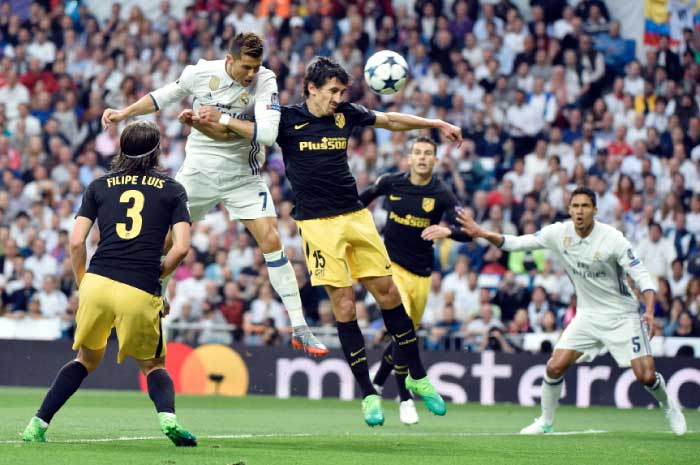 Real Madrid’s forward Cristiano Ronaldo (2nd L) heads to score during the UEFA Champions League semifinal first leg match against Atletico de Madrid at the Santiago Bernabeu Stadium in Madrid Tuesday. — AFP