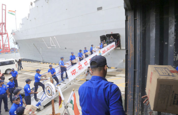 Sri Lankan navy soldiers unload supplies to be used in relief operations from NS Jalashwa Indian Navy ship, Colombo, Sri Lanka, on Tuesday. — AP