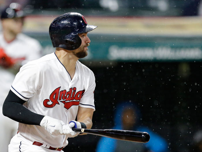 Cleveland Indians' Lonnie Chisenhall watches the ball after hitting a two-run single off Texas Rangers’ relief pitcher Alex Claudio during their MLB game in Cleveland Monday. — AP