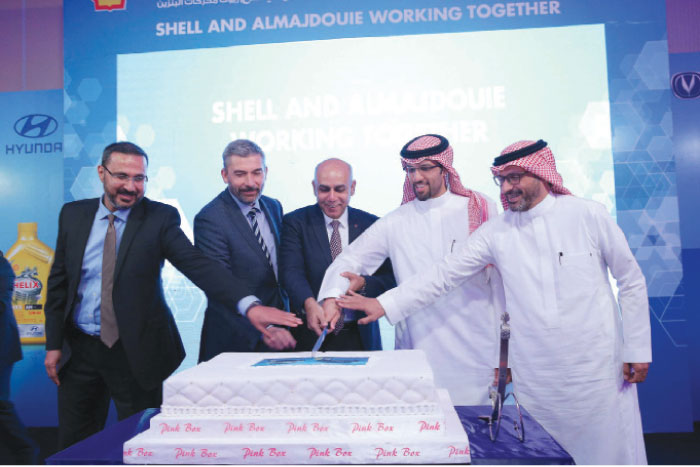 Top executives of signatory companies cut the ceremonial cake