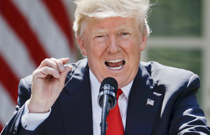 President Donald Trump gestures while speaking about the US role in the Paris climate change accord, Thursday, June 1, 2017. — AP