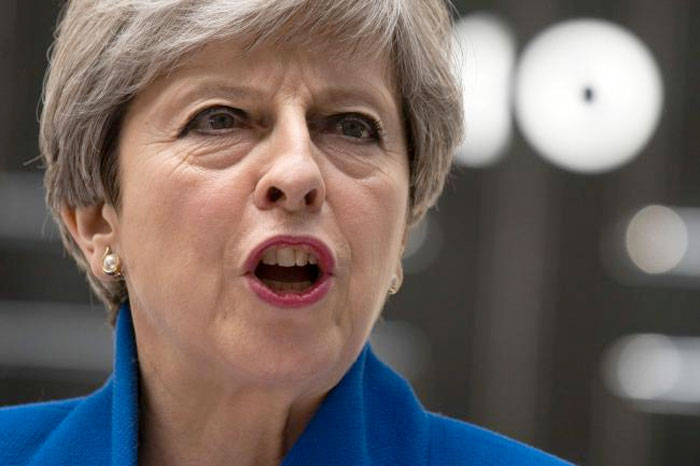 Britain's Prime Minister and leader of the Conservative Party Theresa May delivers a statement outside 10 Downing Street in central London. — AFP