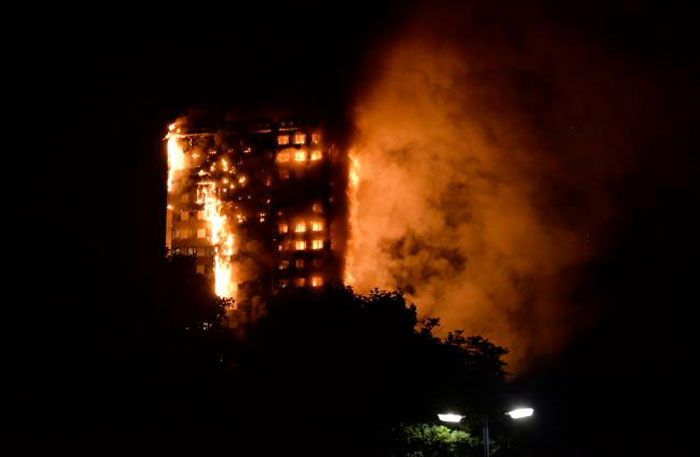 This handout image received by local resident Giulio Thuburn early on June 14, 2017 shows flames engulfing a 27-storey block of flats in west London. — AFP