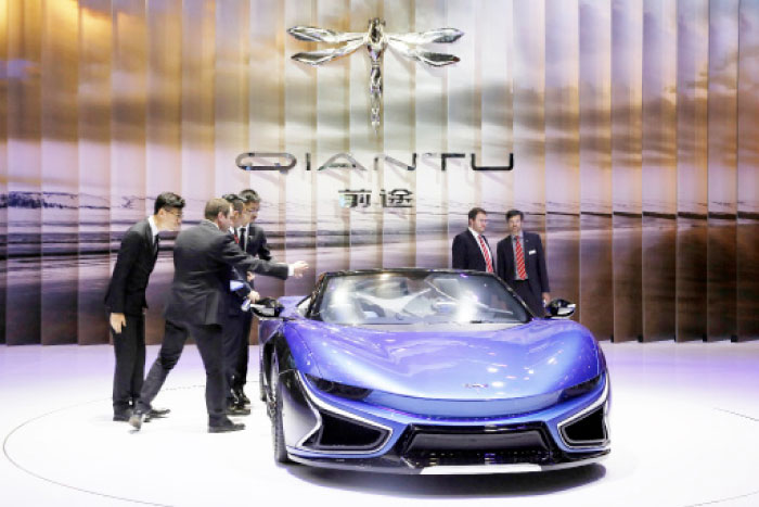 Visitors look at the Qiantu K50 displayed at the Shanghai Auto Show in this April 2017 file photo. — AP