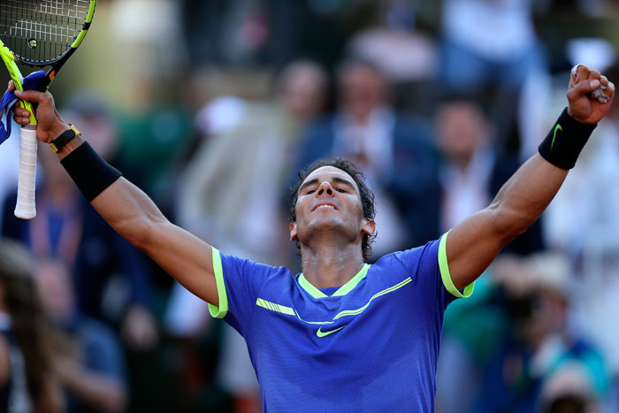 Spain's Rafael Nadal raises his arms in victory after defeating Austria's Dominic Thiem during their semifinal match of the French Open Tennis Tournament at the Roland Garros Stadium in Paris Friday. — AP