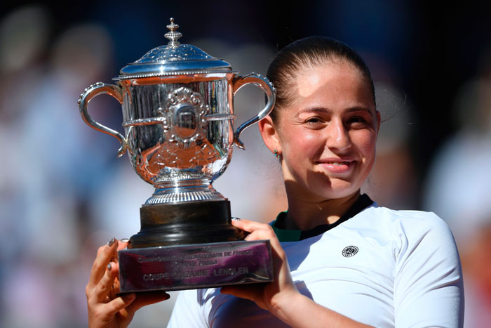 Latvia's Jelena Ostapenko celebrates with her trophy after beating Romania's Simona Halep at the Roland Garros 2017 French Open final in Paris Saturday. — AFP 