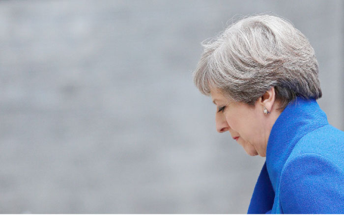 Britain’s Prime Minister and leader of the Conservative Party Theresa May returns to 10 Downing Street in central London after making a statement following the results of a snap general election. — AFP