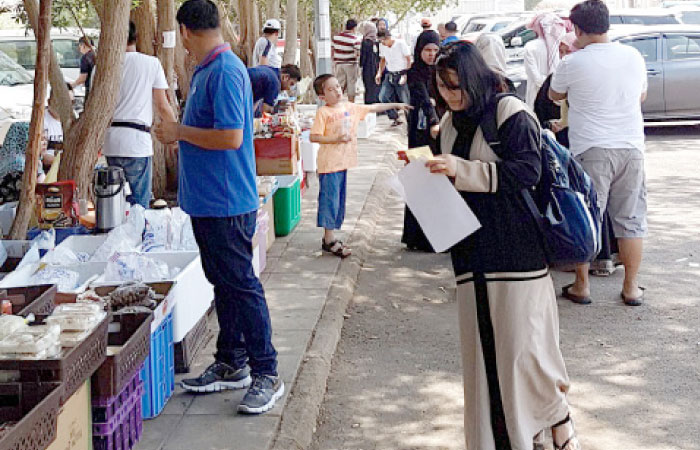 Filipino workers outside their consulate in Jeddah. — SG Photo by Irfan Mohammed