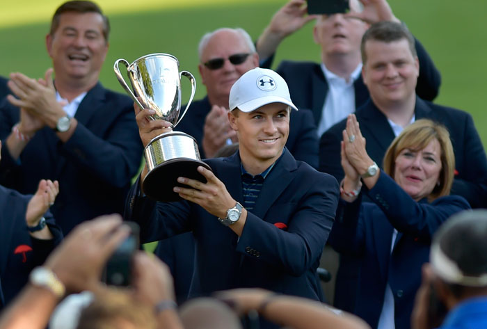 Jordan Spieth holds up the Travelers Golf Championship Trophy in Cromwell Sunday. — AP