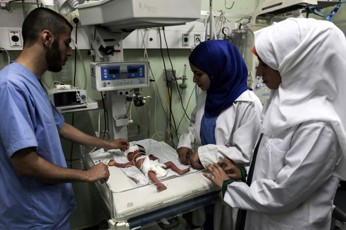 Palestinian nurses tend to a newborn at the neonatal intensive care unit at the UAE hospital in Rafah in the southern Gaza Strip on Tuesday. Hamas accused the Palestinian Authority and Israel of refusing to grant documents to Gazans in need of permission to seek medical treatment outside the blockaded coastal enclave. — AFP