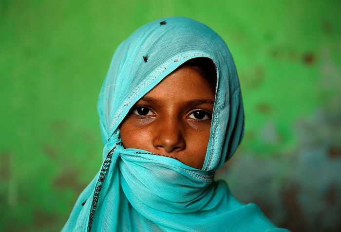 A Muslim girl poses as she shelters from the sun in the village of Jaisinghpura in the northern state of Haryana, India, in this filer.  — Reuters