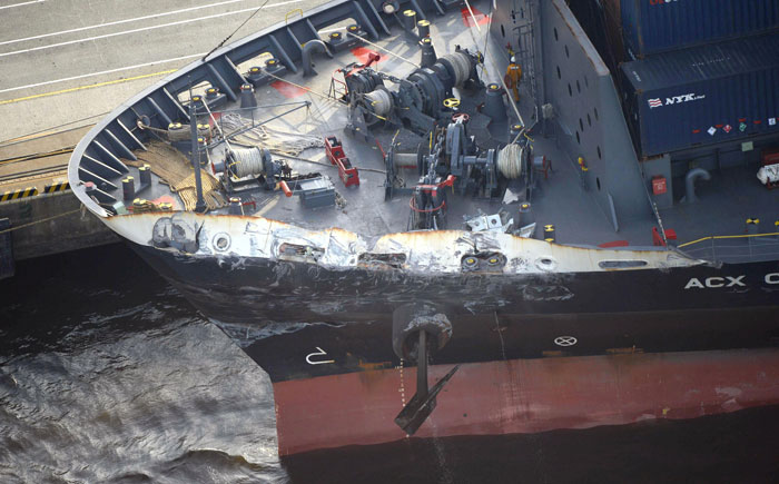 In this file photo, the container ship ACX Crystal with its left bow dented and scraped after colliding with the USS Fitzgerald off Japan earlier in the day, is berthed at the Oi Container Terminal in Tokyo. — AP