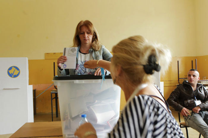 A woman casts her vote at a polling station during the Parliamentary elections in Gracanica, Kosovo, on Sunday. — Reuters