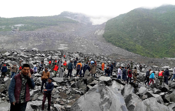 Chinese military police and rescue workers are seen at the site of a landslide in in Xinmo village, Diexi town of Maoxian county, Sichuan province on Saturday. — AFP