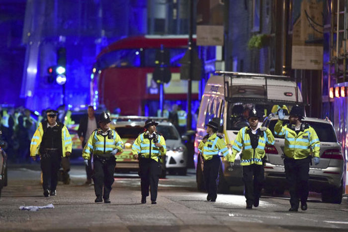 Police officers on Borough High Street as police are dealing with an incident on London Bridge in London. — AP