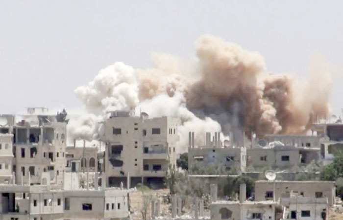 This file frame grab from video provided on June shows smoke rising over buildings that were hit by Syrian government forces bombardment in Daraa city, southern Syria. — AP