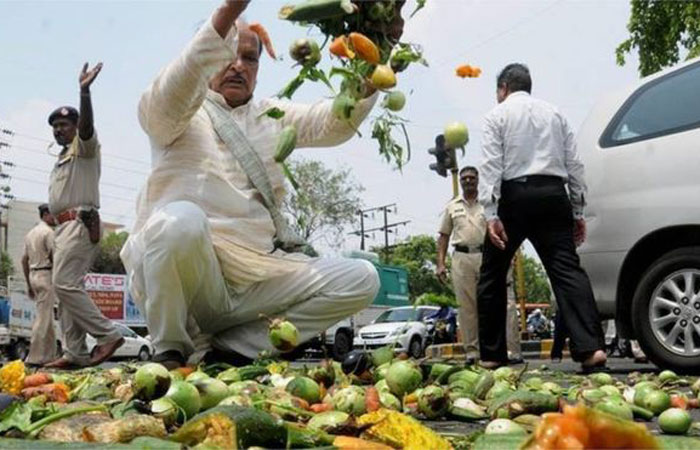 Farmers throwing vegetables on a road during a protest of Maharashtra bandh over writing off loans. The Maharashtra state is to waive $5.27 billion in farm debts. — Courtesy photo