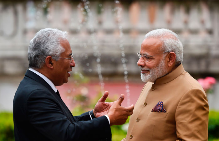 Portuguese Prime Minister Antonio Costa (L) speaks with his Indian counterpart Narendra Modi as they walk through the palace gardens moments after their meeting at Necessidades Palace in Lisbon on Saturday. — AFP