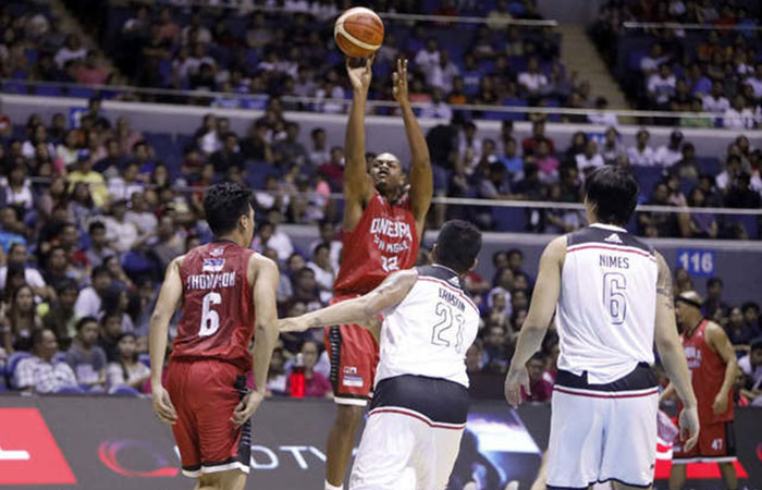 Barangay Ginebra's Justin Brownlee fires a shot off Mahindra's Eric Camson in the final elimination round game of the 2017 PBA Commissioner's Cup at the Smart-Araneta Coliseum Friday night.