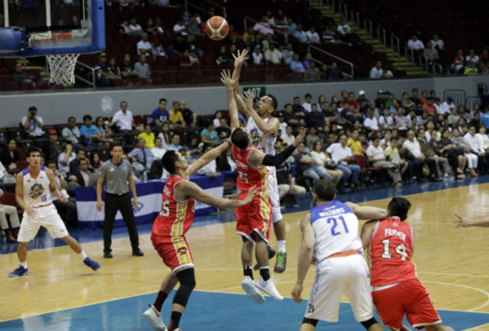 TNT's Jayson Castro elevates for a jump shot off Ginebra's LA Tenorio and Japeth Aguilar in Game 2 of their PBA Commissioner's Cup semifinals at the Mall of Asia Arena on Tuesday night. — SG photo