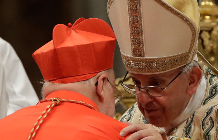 New Cardinal Anders Arborelius, Archbishop of Stockholm, receives the red three-cornered biretta hat from Pope Francis during a consistory inside the St. Peter's Basilica at the Vatican, Wednesday. — AP
