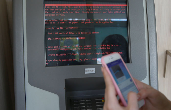 A message demanding money is seen on a monitor of a payment terminal at a branch of Ukraine's state-owned bank Oschadbank after Ukrainian institutions were hit by a wave of cyber attacks earlier Tuesday, in Kiev. — Reuters