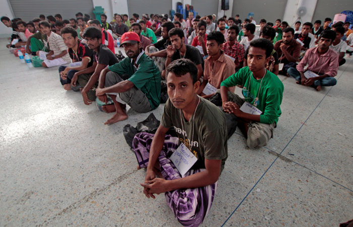 Suspected Rohingya migrants from Myanmar and Bangladesh rest at Rattaphum district hall in Thailand's southern Songkhla province in this file photo. — Reuters