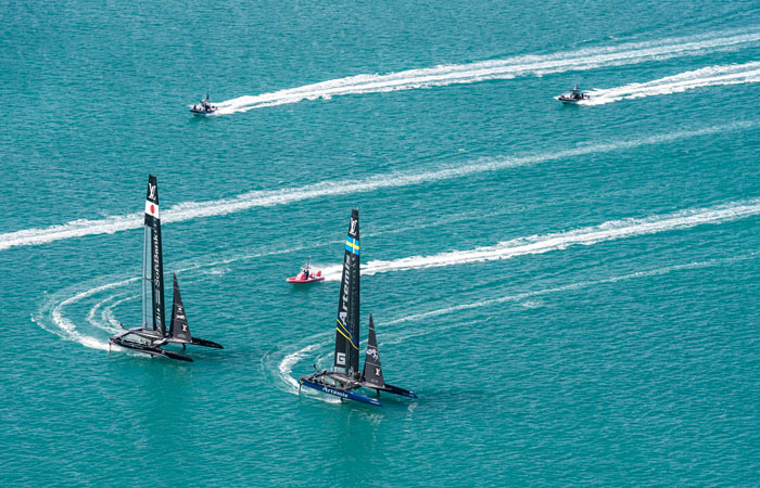 SoftBank Team Japan, left, and Artemis Racing compete in America's Cup challenger semifinals on the Great Sound in Bermuda on Monday. — AP