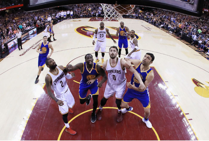 Kyrie Irving (No. 2) and Kevin Love (No. 0) of the Cleveland Cavaliers compete for position with Draymond Green (No. 23) and Zaza Pachulia (No. 27) of the Golden State Warriors during Game 4 of the 2017 NBA Finals at Quicken Loans Arena in Cleveland Friday. — AFP