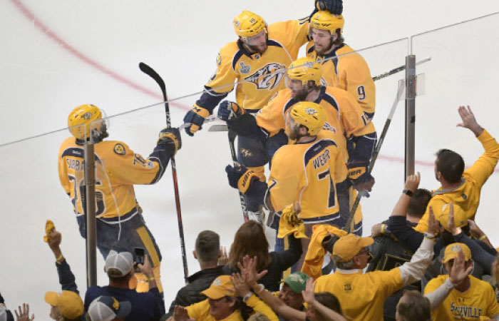 Nashville Predators’ center Craig Smith is congratulated by teammates after scoring a goal against the Pittsburgh Penguins during Game of the 2017 Stanley Cup Finals at Bridgestone Arena in Nashville Saturday. — Reuters
