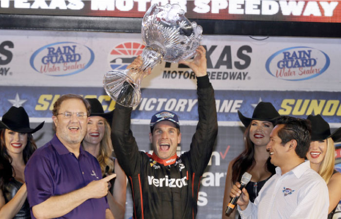 Will Power of Australia holds up the trophy in Victory Lane as track president Eddie Gossage (L) points at him after Power won the IndyCar Auto Race at Texas Motor Speedway in Fort Worth, Texas, Saturday. — AP