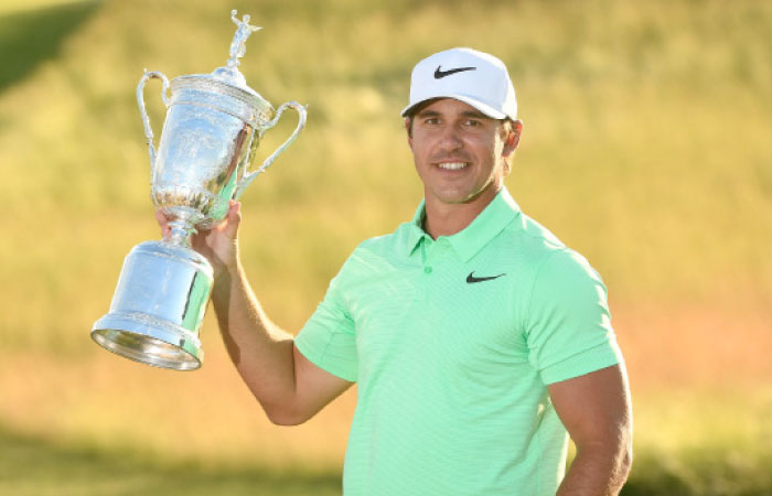 Brooks Koepka poses with the trophy after winning the US Open Golf Tournament at Erin Hills Sunday. — Reuters