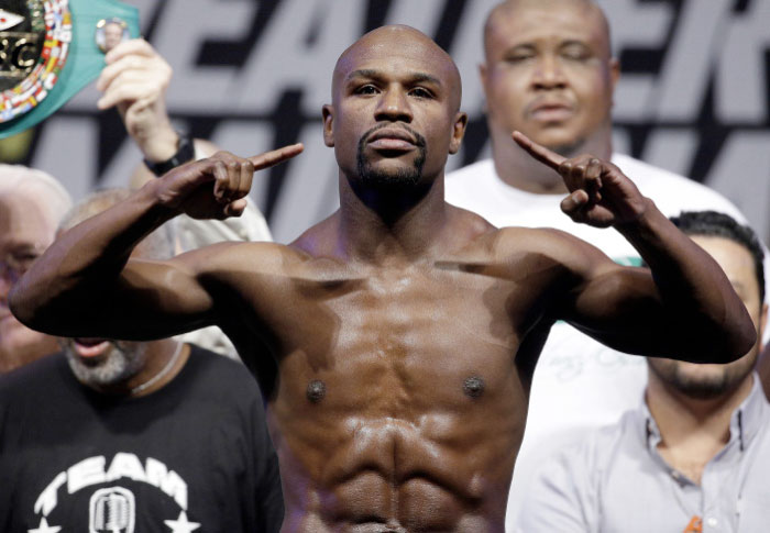 In this Sept. 12, 2014, file photo, Floyd Mayweather Jr. poses on the scale during a weigh in for a fight against Marcos Maidana in Las Vegas. — AP