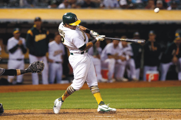 Khris Davis of the Oakland Athletics hits a walk off two-run single during the tenth inning against the New York Yankees at the Oakland Coliseum in Oakland Thursday. — AFP