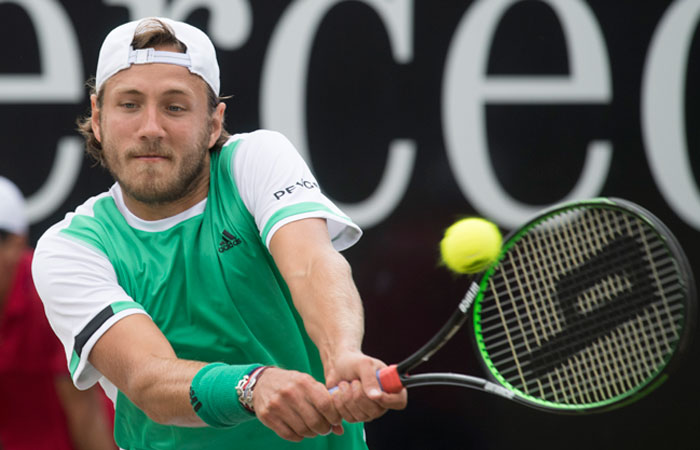 France's Lucas Pouille returns the ball to his fellow countryman Benoit Paire in their semifinal match at the ATP Mercedes Cup Tennis Tournament in Stuttgart Saturday. — AFP