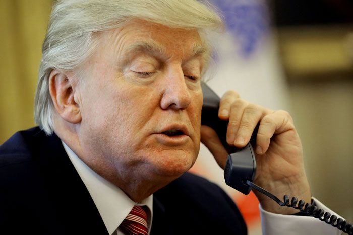 US President Donald Trump waits on the line as he calls Irish Prime Minister Leo Varadkar to congratulate him on his victory in the Oval Office of the White House in Washington on Yuesday. — Reuters