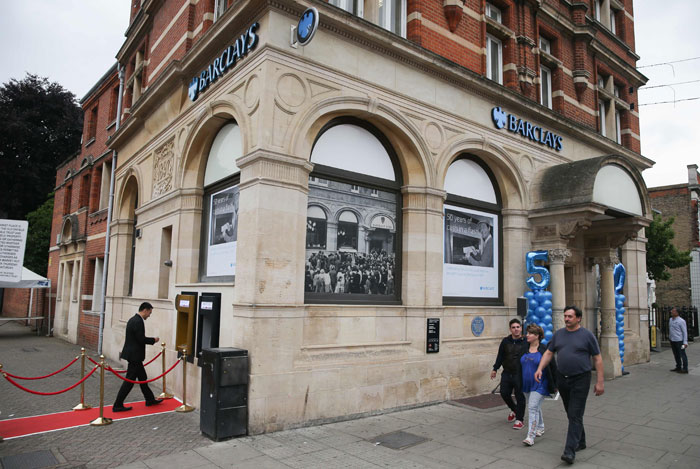 A man uses a gold colored automated teller machine (ATM), outside a branch of British bank Barclays, in Enfield north London on Tuesday, on the 50th anniversary of the UK's first cash machine. Barclays is one of the several UK banks to stap dealing in Qatari riyals. Barclays stopped trading riyals for retail customers but continued the service for corporate customers. — AFP